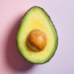 Avocado half on pink background, studio photo
