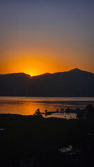 Golden sunset over Zarivar Lake reflects on tranquil water with mountain silhouettes, blending warm light and peaceful scenery in a breathtaking natural moment.  
📍Marivan, Kurdistan 