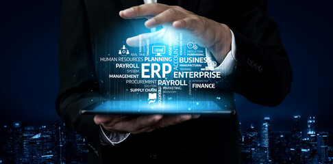 A business professional showcases a digital interface featuring ERP and finance concepts above a tablet, set against a vibrant night city backdrop, symbolizing innovation. Tessel