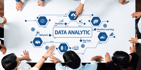 A diverse team collaborates on data analytic strategies, utilizing machine learning and statistics to enhance performance in a modern workspace environment. Amity