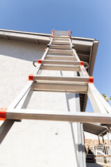 ladder leaning against a roof of a home