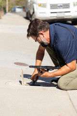 Home inspector checking the water meter outside the home. 