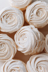 Delicate white marshmallow dessert in natural light, close-up of airy texture and swirl shape