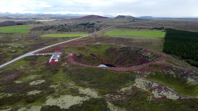 Drone Overview of Kerid Crater With Parking Lot and Tourists