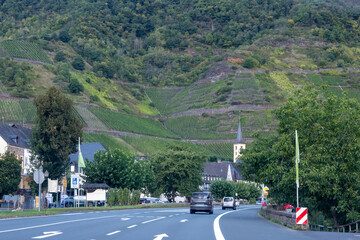Driving car on road with forests in Calmont region with steepest vineyard in Europe on Moselle...