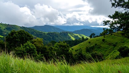 Obraz premium Lush green hills under a cloudy sky