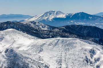 Obraz premium Plume of steam rising from snow-capped Mt. Asama volcano in the Japanese Alps.