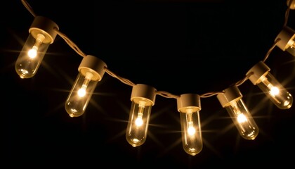 Decorative string lights glowing against a dark background  