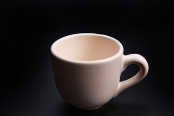 Cup, beautiful cup alone placed on a dark background, selective focus.