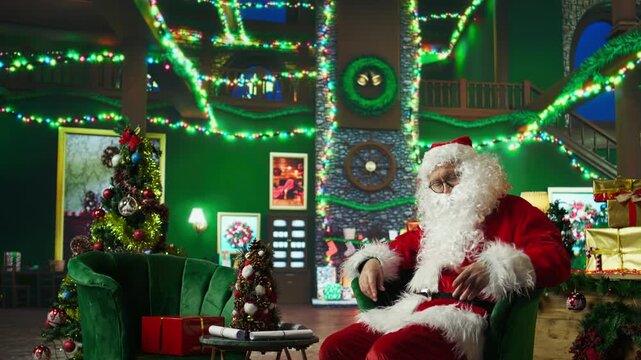 Santa Claus waking up from sleep to deliver gifts to children on Christmas Eve, making dreams come true. Entertainer with fake beard waking up after dozing off, rushing to send Xmas presents, camera A