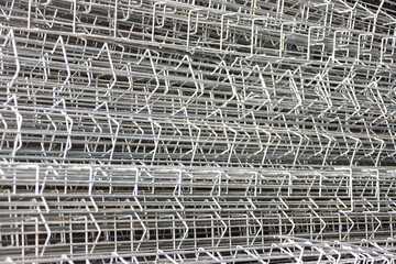Obraz premium galvanized wire mesh pile, steel reinforcement field fence, abstract texture close up macro