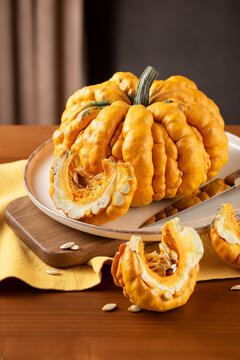 Guicoy Pumpkin And Wedges Prepared On Kitchen Table