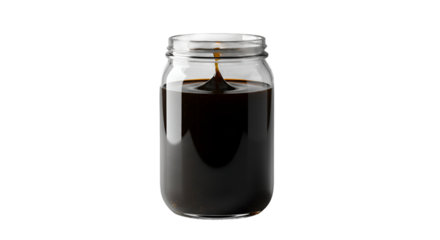 Thick Dark Syrup Drop Splashing into Clear Glass Jar