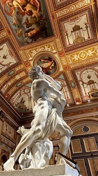 Classical Sculpture of &lsquo;The Rape of Proserpina&rsquo; by Bernini Under Ornate Renaissance Ceiling in Museum Hall