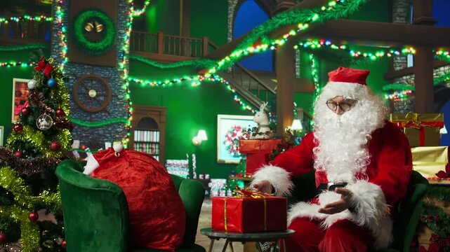 Amazed Santa Claus surprised to find gift box for him in cozy Christmas decorated room. Elderly man playing Santa Claus astonished after finding present on table, Christmas miracle concept, camera A