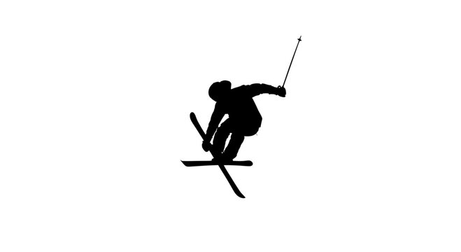 Dynamic silhouette of a freestyle skier performing a trick on a snow covered mountain slope