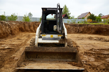 Excavator in the excavation at the construction site during the day