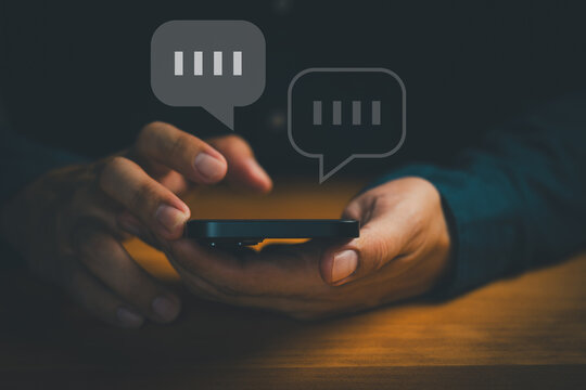 Close-up of hands using smartphone with chat bubbles, symbolizing online messaging, instant communication, mobile chat apps, digital conversation, customer support, social interaction in technology.