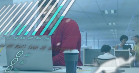 Working red-sweatered man with glasses analyzing laptop data in open-plan office holding coffee cup