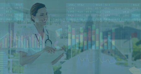 Interacting professional with stethoscope analyzing tablet data in hospital corridor, copy space