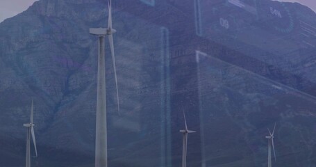 Towering large wind turbine capturing data analytics over mountain valley, with blue data overlays