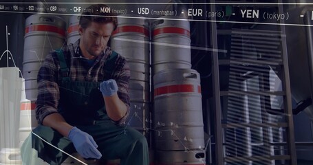Inspecting worker wearing overalls adjusting glove on keg in storage area, with chart overlay