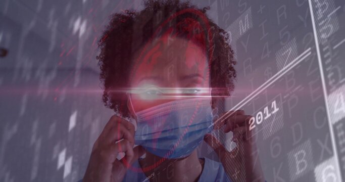 Adjusting African American woman in scrubs fitting surgical mask in clinic hallway, digital overlay