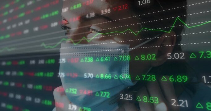 Finance analyst wearing surgical mask analyzing market data in trading office, with ticker overlay - Powered by Adobe