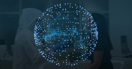 Collaborating IT pros analyzing holographic digital globe projection at office, with monitors