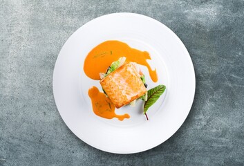Tasty fresh fish dish on desk background