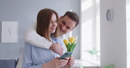 Unexpected flower gift boutique, loving man, husband with flowers giving woman girlfriend present making romantic surprise to wife, couple celebrating Valentines day, birthday, marriage relationship - Powered by Adobe