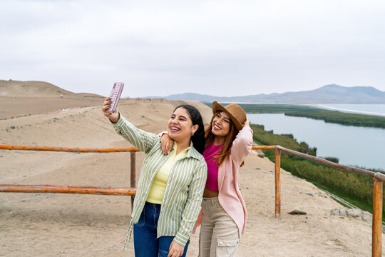Tourists taking selfie at cerro culebras, pre inca ruins in paracas national reserve, peru