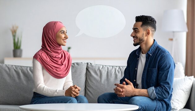Couple seated on a couch, looking at each other with a blank speech bubble above their heads - Powered by Adobe