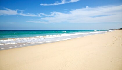Fototapeta premium Idyllic beach scene with pristine sand and turquoise water under clear sky