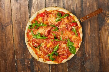 Thin crust tasty pizza Margherita with tomatoes and basil.