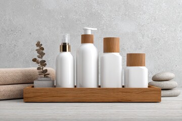 Spa Still Life: White Bottles, Wooden Tray, and Zen Stones on White Wood