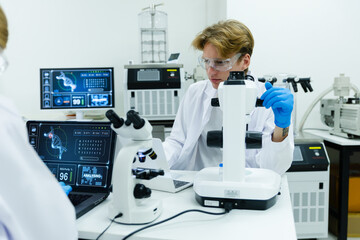Scientists analyzing DNA data in high-tech lab.