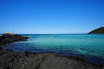 clear blue sea and rock coast