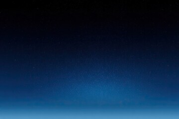 Deep space, star-studded night sky fades to light blue horizon