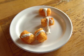 Cajun Tater Tots on a White Plate with a Drizzle orf Ranch Dressing 2