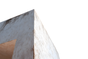 A weathered, light gray corner of a building, angled against a stark black background, showcasing a textured surface and a muted light source.