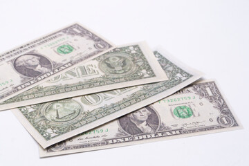 Stack of Four United States One Dollar Bills on White Background, Currency, Finance.