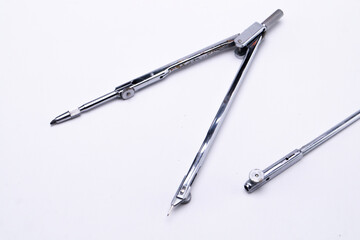 Silver Drawing Compass on White Background, Precision Tool for Geometry and Technical Drawing.