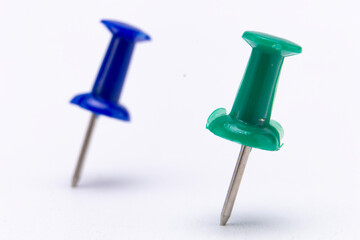 Blue and Green Push Pins Isolated on White Background, Close-Up View.