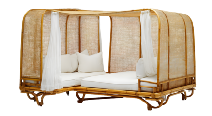 A charming, light-toned, woven bamboo daybed with a canopy and white cushions exudes an airy, relaxing ambiance.
