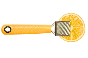 Small handheld kitchen zester grater on a fresh lemon slice isolated with transparent background