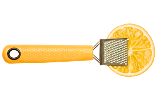 Small handheld kitchen zester grater on a fresh lemon slice isolated with transparent background