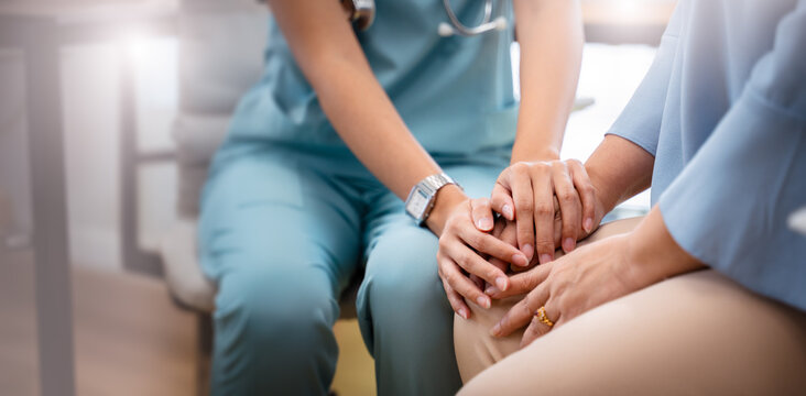 Doctor or Mental health and elderly care concept.Close up hands of doctor or caregiver hands elderly home care or hospital.Arthritis person's hand in support of geriatric nursing caregiver in hospital
