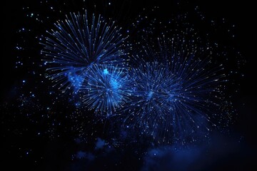 Blue fireworks burst against a night sky