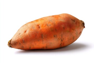 A vibrant orange sweet potato with textured skin lies against a bright white backdrop, casting a subtle shadow